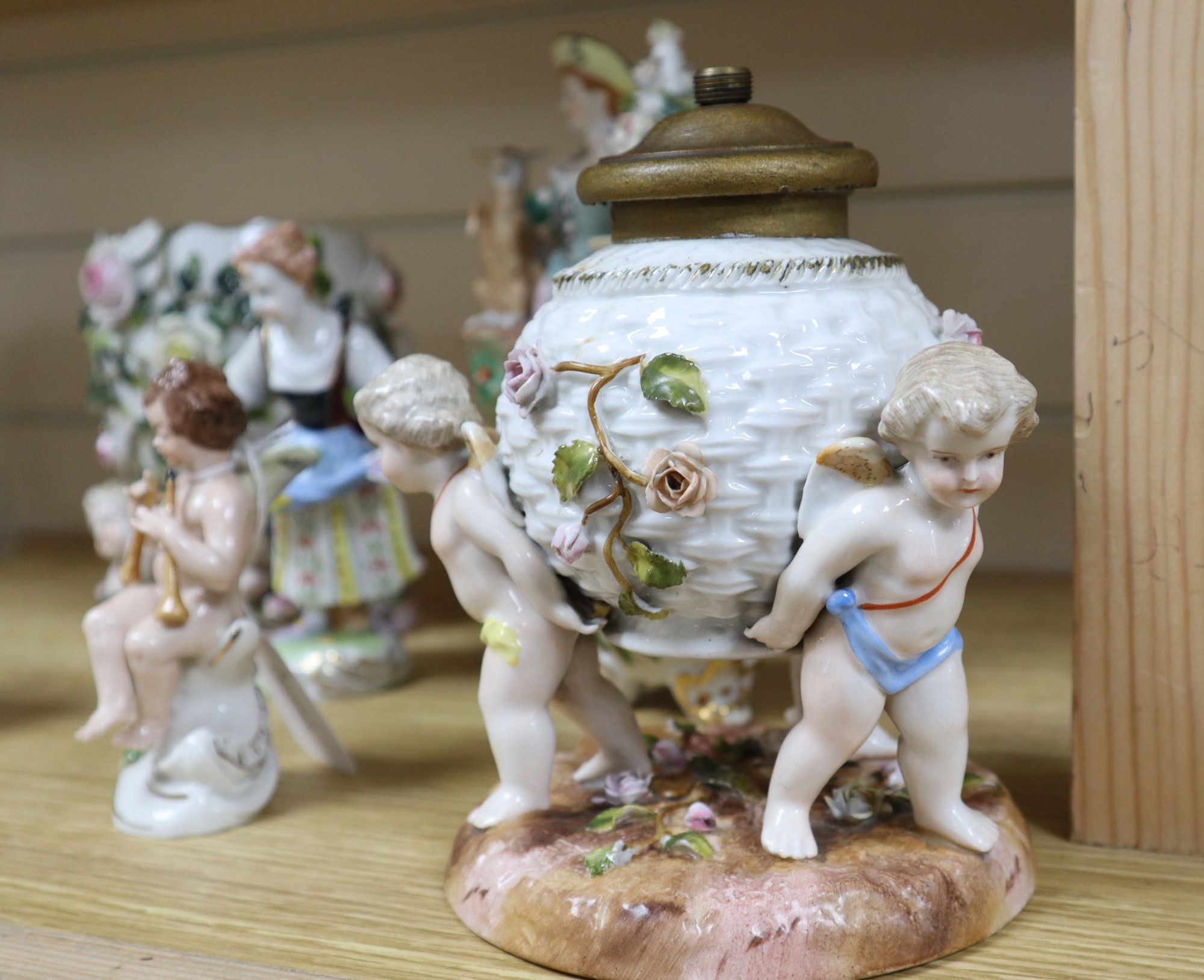 A Sitzendorf flower-encrusted egg-shaped porcelain vase with cherub supports and six other items,
